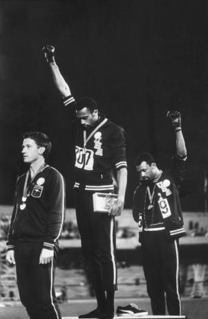 Foto anggota tim track Amerika-Afrika-Amerika, Tommie Smith dan John Carlos mengangkat tinju Black Power sebagai protes hak-hak sipil selama upacara medali pada Olimpiade 1968 di Mexico City